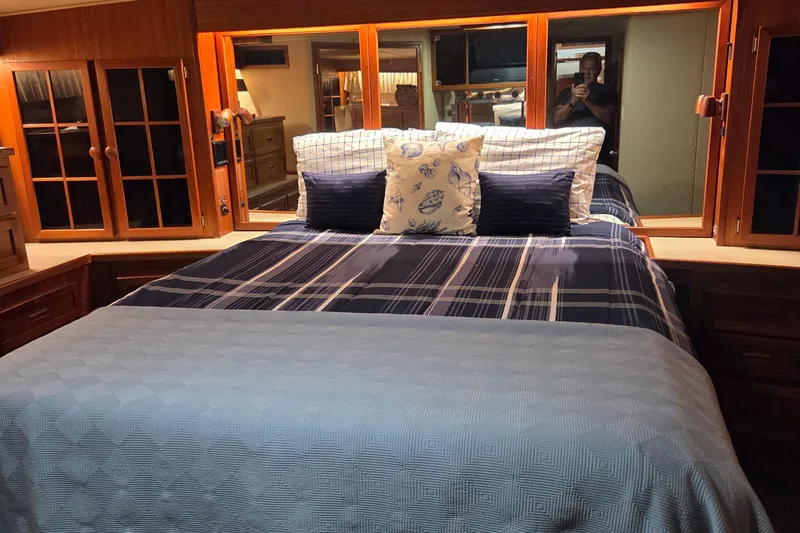 Pazzaz Yacht Photos Pics Luxurious bedroom interior of 1985 Chris-Craft 500 Constellation Motor Yacht with elegant bedding.