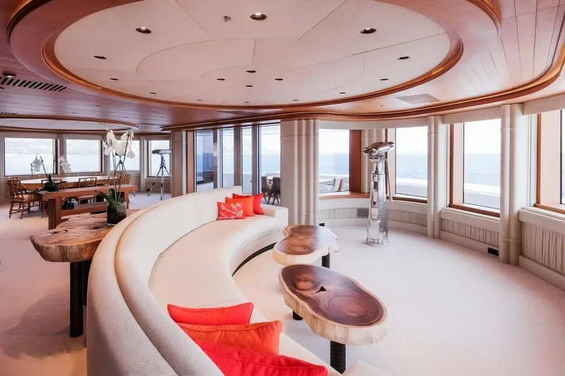 Luna Yacht Photos Pics Luxurious yacht interior with curved seating, ocean view, and elegant wooden accents.