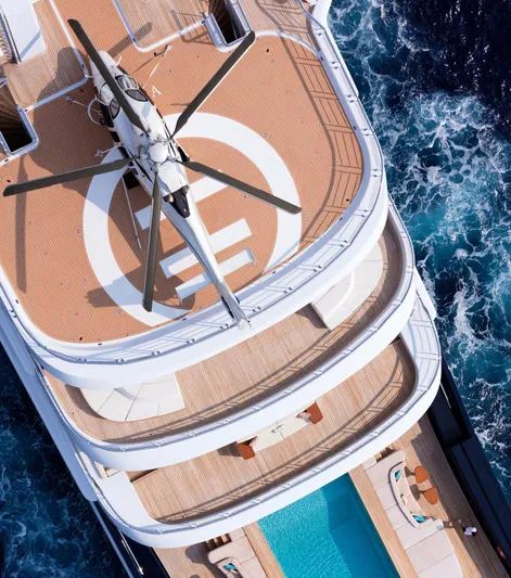 Luna Yacht Photos Pics Luxurious yacht with helicopter and pool, Custom Lloyd Werft 2010, cruising through ocean waves.