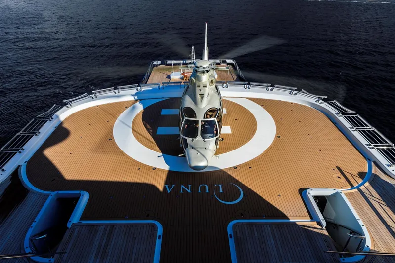 Luna Yacht Photos Pics Helicopter on luxury yacht helipad, Custom Lloyd Werft 2010, ocean backdrop.