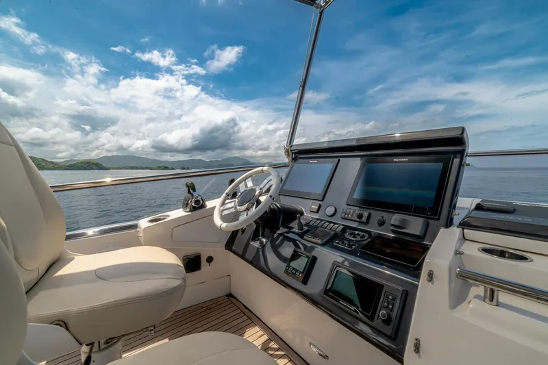 Carpe Diem Yacht Photos Pics Cockpit of 2017 Azimut 77S yacht with navigation screens and ocean view.