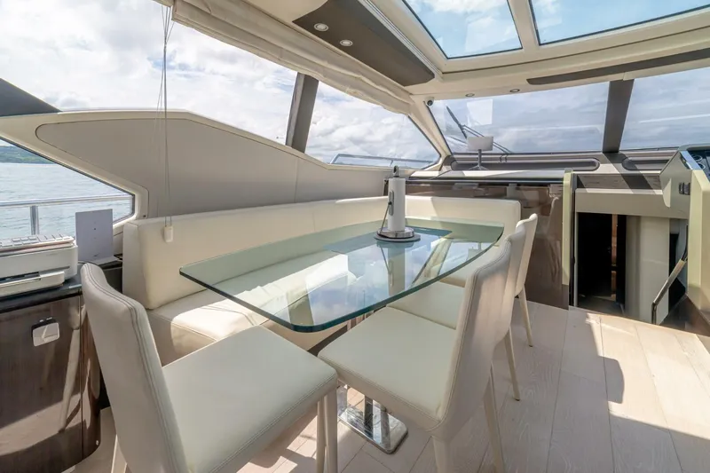 Carpe Diem Yacht Photos Pics Luxurious interior of 2017 Azimut 77S yacht with glass dining table and panoramic windows.