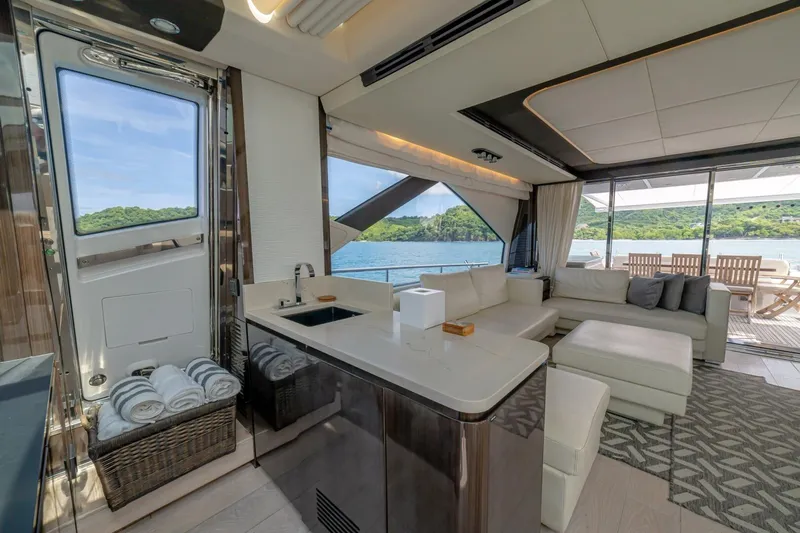 Carpe Diem Yacht Photos Pics Luxurious interior of 2017 Azimut 77S yacht with modern furnishings and scenic ocean view.