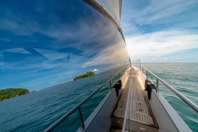 Carpe Diem Yacht Photos Pics Azimut 77S yacht cruising on open sea, reflecting sky and water, 2017 model.