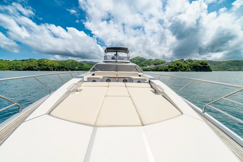 Carpe Diem Yacht Photos Pics Luxurious 2017 Azimut 77S yacht cruising on serene waters under a partly cloudy sky.