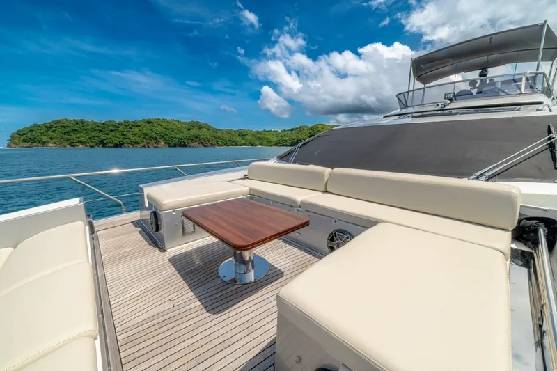 Carpe Diem Yacht Photos Pics Luxurious 2017 Azimut 77S yacht deck with seating, table, and scenic ocean view.
