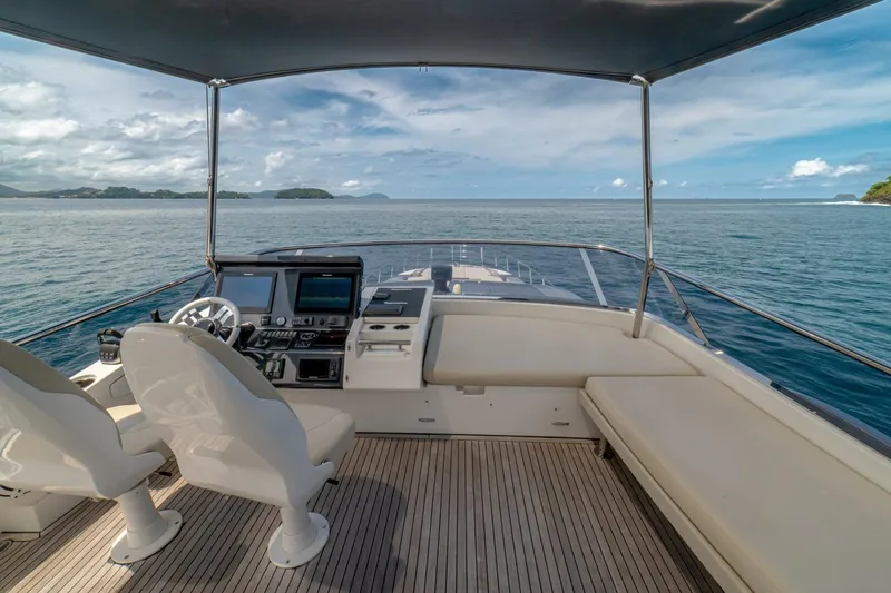 Carpe Diem Yacht Photos Pics 2017 Azimut 77S yacht helm with ocean view, featuring modern navigation equipment and seating.