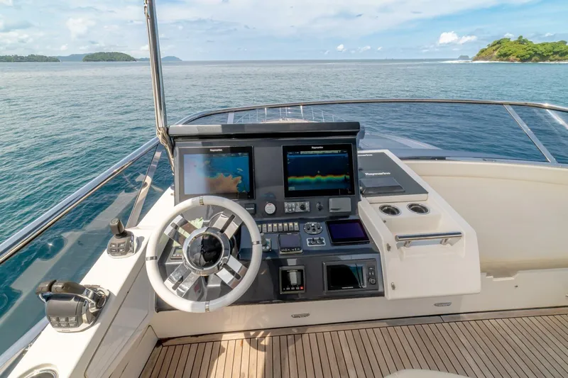 Carpe Diem Yacht Photos Pics Cockpit of 2017 Azimut 77S yacht with navigation screens and steering wheel.