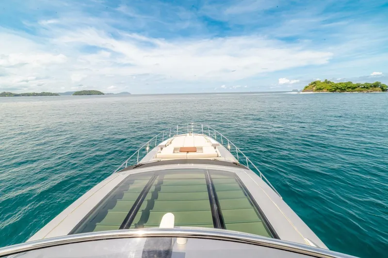 Carpe Diem Yacht Photos Pics Azimut 77S yacht cruising on open sea, 2017 model, with scenic island views.