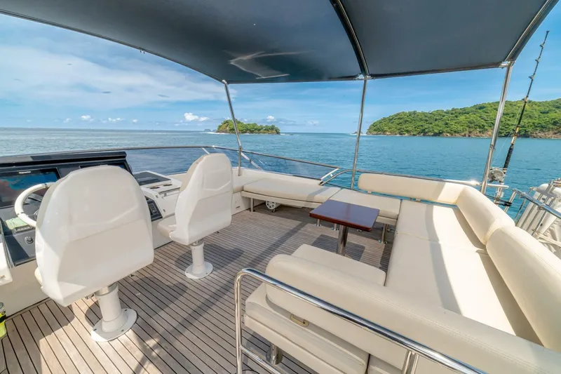 Carpe Diem Yacht Photos Pics Luxurious 2017 Azimut 77S yacht deck with seating, ocean view, and canopy.