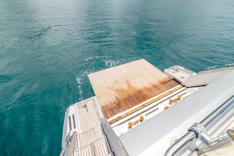 Carpe Diem Yacht Photos Pics Azimut 77S 2017 yacht's teak swim platform on calm blue water.