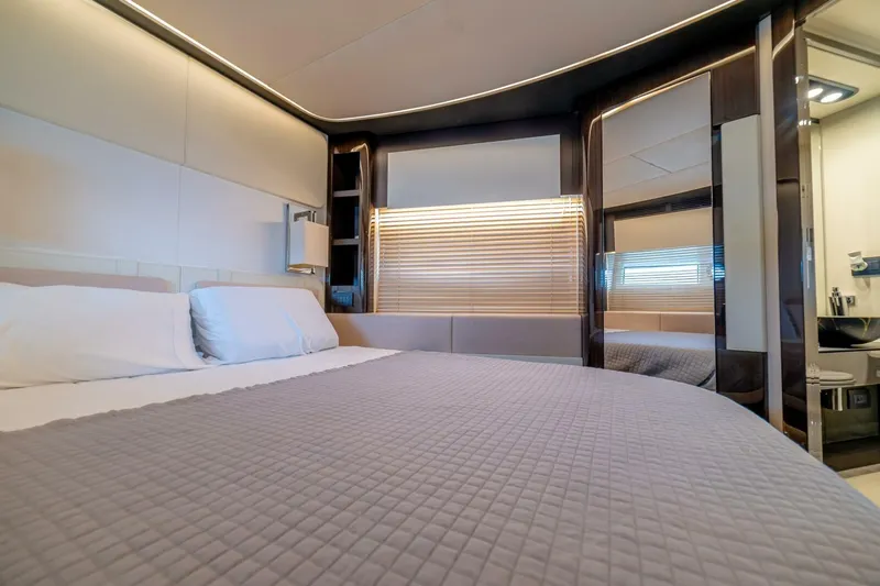 Carpe Diem Yacht Photos Pics Luxurious bedroom interior of 2017 Azimut 77S yacht with modern design and elegant furnishings.