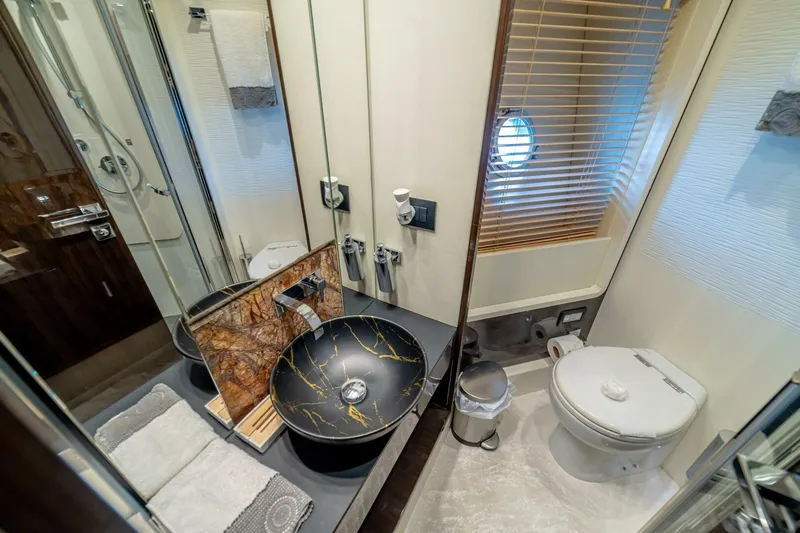 Carpe Diem Yacht Photos Pics Luxurious bathroom in 2017 Azimut 77S yacht with elegant sink and modern fixtures.