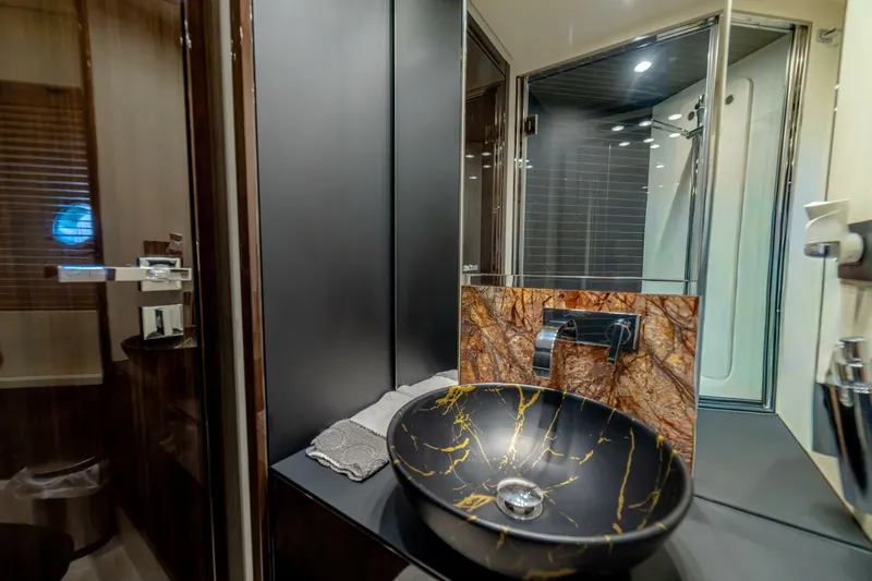 Carpe Diem Yacht Photos Pics Luxurious bathroom in 2017 Azimut 77S yacht with elegant vessel sink and modern fixtures.