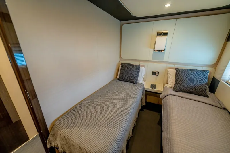 Carpe Diem Yacht Photos Pics Luxurious twin bedroom on 2017 Azimut 77S yacht with modern decor and cozy bedding.