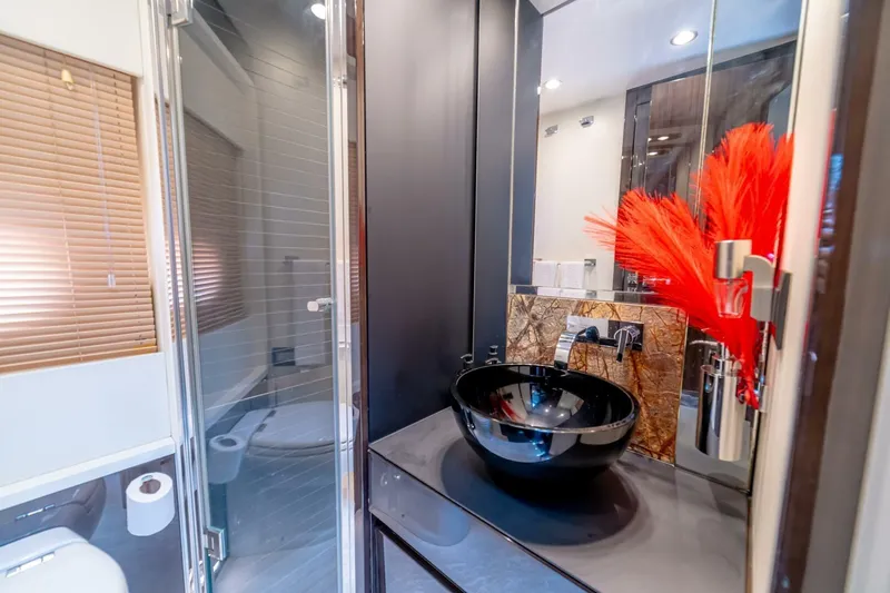 Carpe Diem Yacht Photos Pics Luxurious bathroom on 2017 Azimut 77S yacht with modern black sink and vibrant decor.
