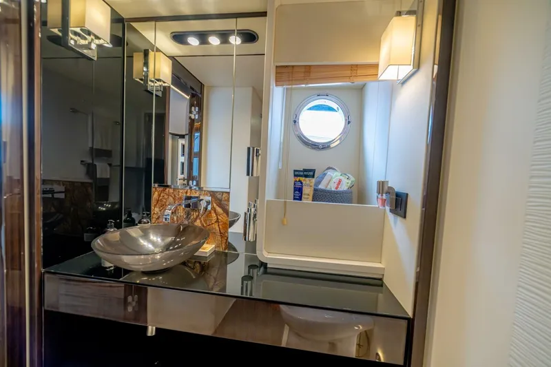 Carpe Diem Yacht Photos Pics Luxurious bathroom interior of 2017 Azimut 77S yacht with modern fixtures and porthole window.