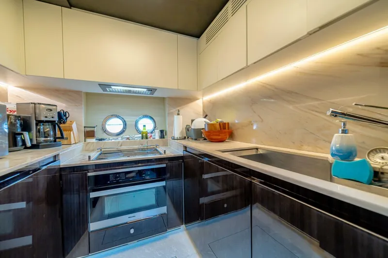 Carpe Diem Yacht Photos Pics Luxurious kitchen interior of 2017 Azimut 77S yacht with modern appliances and sleek design.