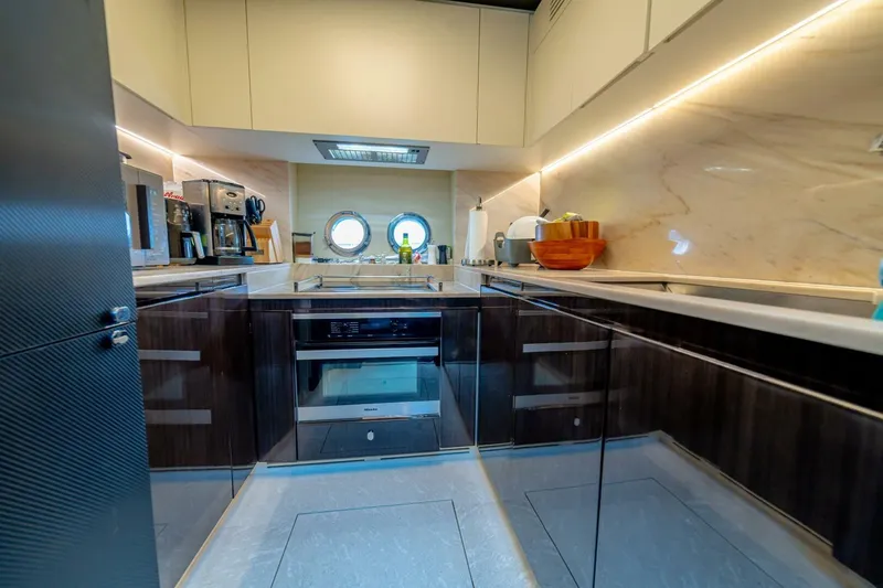 Carpe Diem Yacht Photos Pics Luxurious kitchen interior of 2017 Azimut 77S yacht with modern appliances and sleek design.
