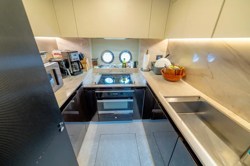 Carpe Diem Yacht Photos Pics Luxurious kitchen interior of 2017 Azimut 77S yacht with modern appliances and sleek design.