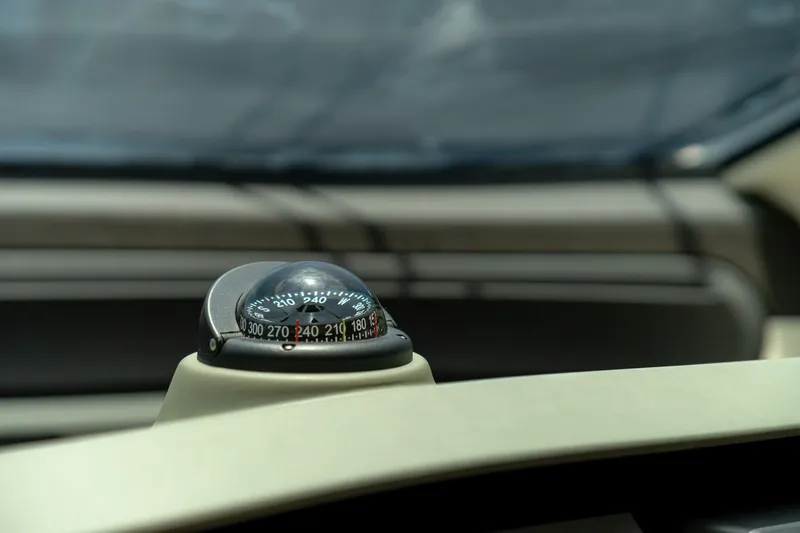 Carpe Diem Yacht Photos Pics Compass on 2017 Azimut 77S yacht dashboard, indicating navigation direction.