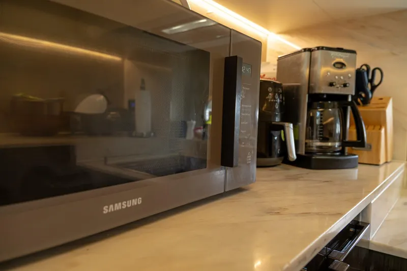 Carpe Diem Yacht Photos Pics Kitchen appliances on Azimut 77S yacht, featuring a Samsung microwave and coffee maker.