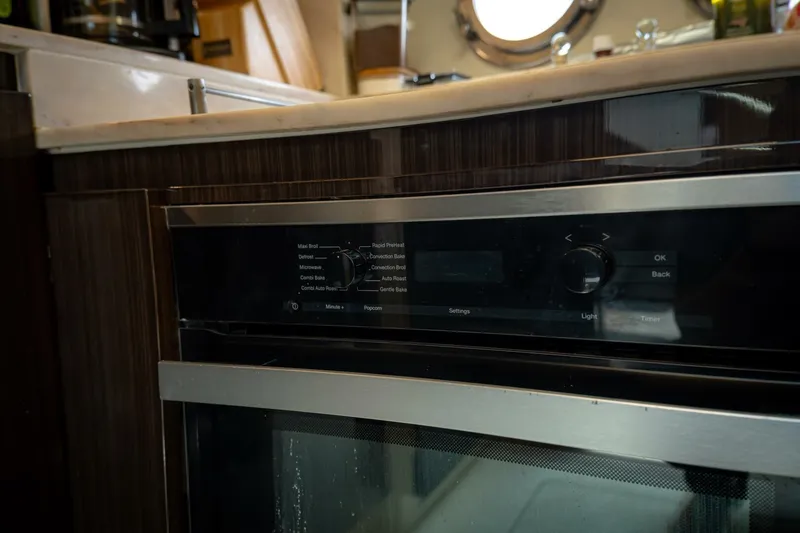 Carpe Diem Yacht Photos Pics Modern kitchen appliance in 2017 Azimut 77S yacht, featuring sleek design and controls.