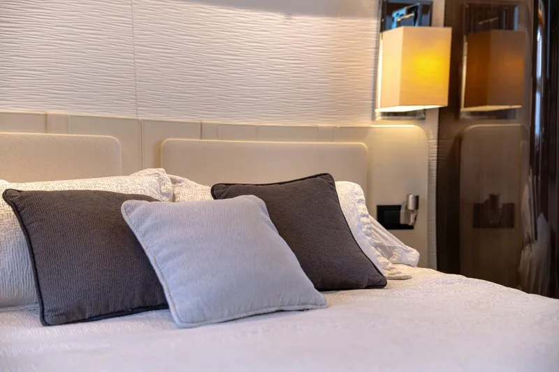 Carpe Diem Yacht Photos Pics Luxurious bedroom interior on 2017 Azimut 77S yacht with elegant pillows and lighting.