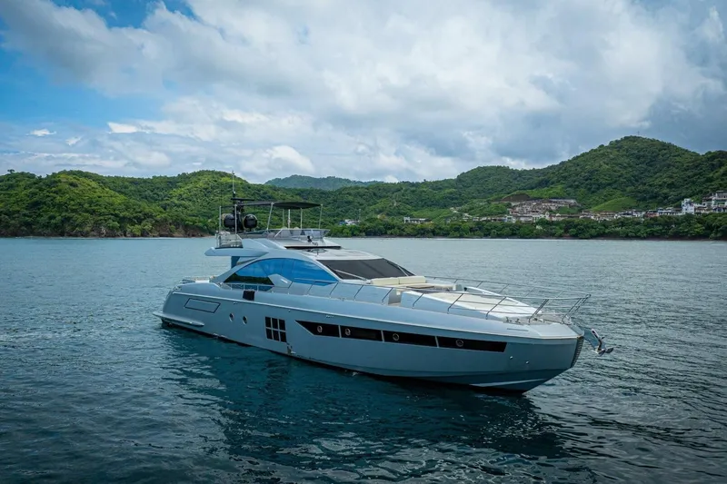 Carpe Diem Yacht Photos Pics 2017 Azimut 77S yacht cruising on serene waters with lush green hills in the background.