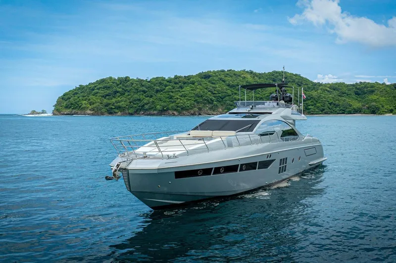 Carpe Diem Yacht Photos Pics Luxury 2017 Azimut 77S yacht cruising near lush green island.