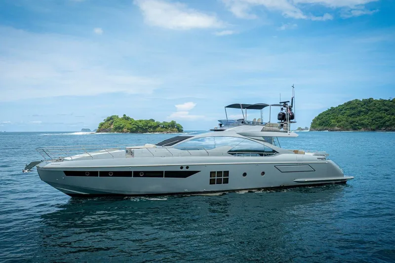 Carpe Diem Yacht Photos Pics 2017 Azimut 77S yacht cruising near lush islands under a clear blue sky.