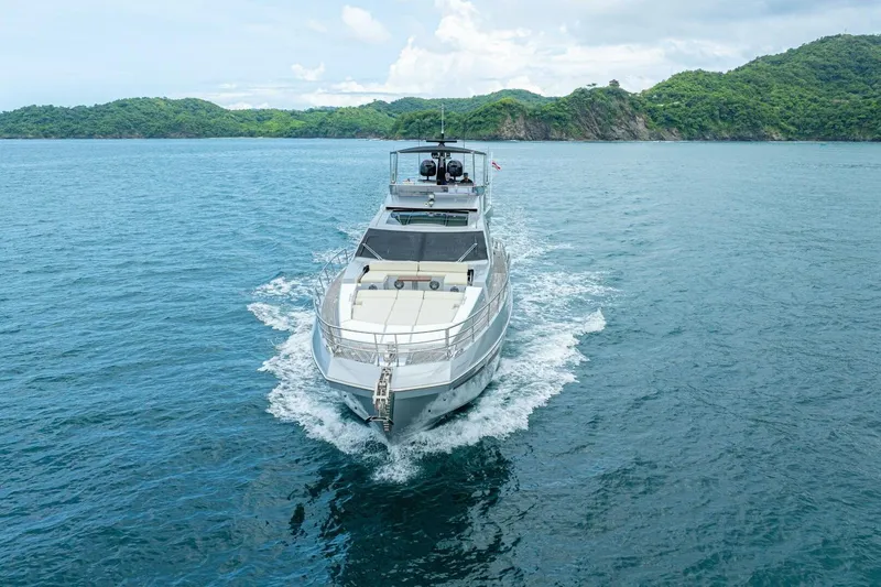 Carpe Diem Yacht Photos Pics Luxury 2017 Azimut 77S yacht cruising on blue ocean near lush green islands.