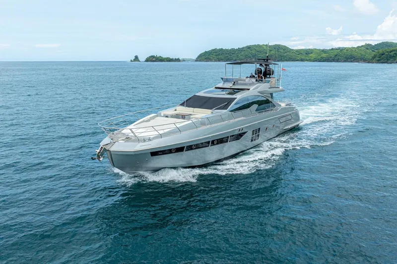 Carpe Diem Yacht Photos Pics Luxury 2017 Azimut 77S yacht cruising on open sea with lush green island backdrop.