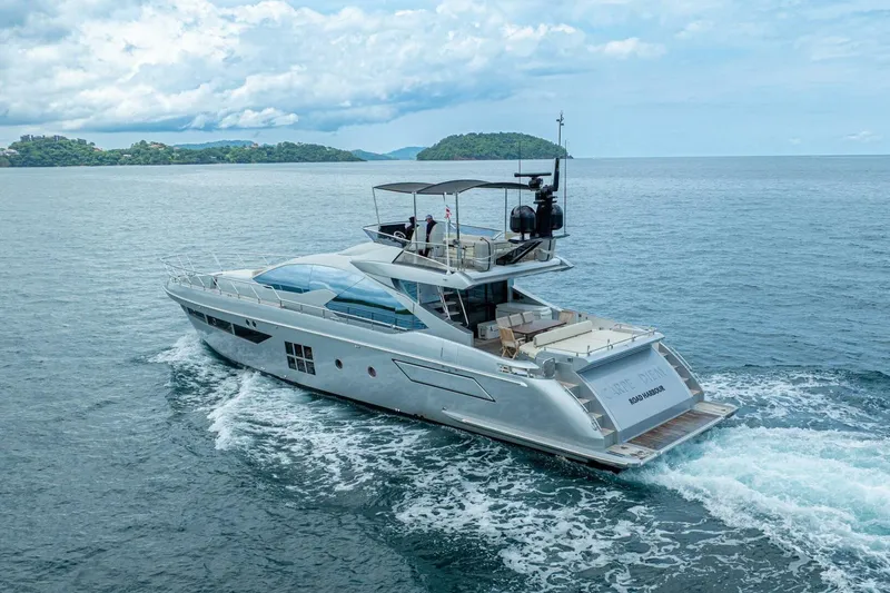 Carpe Diem Yacht Photos Pics Luxurious 2017 Azimut 77S yacht cruising on open water under a cloudy sky.