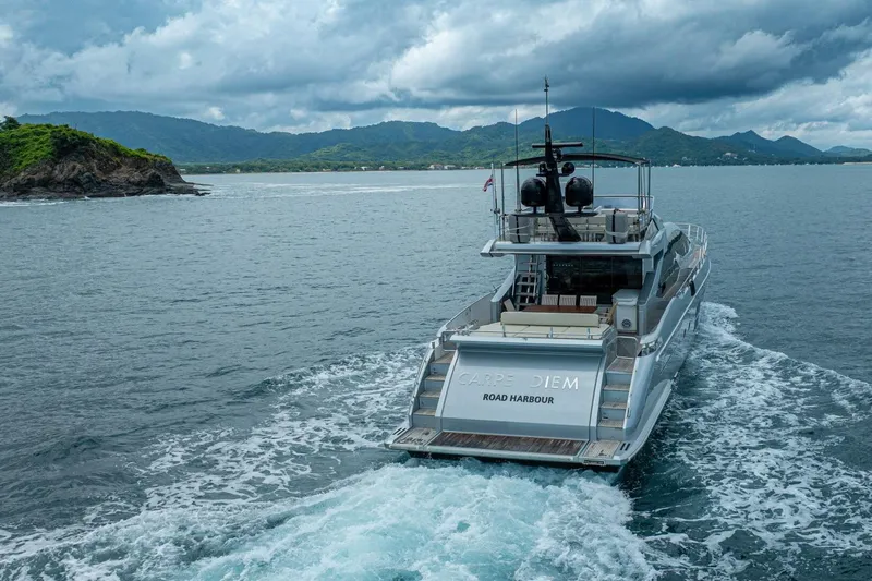 Carpe Diem Yacht Photos Pics Azimut 77S yacht cruising near lush coastline under cloudy skies, 2017 model.