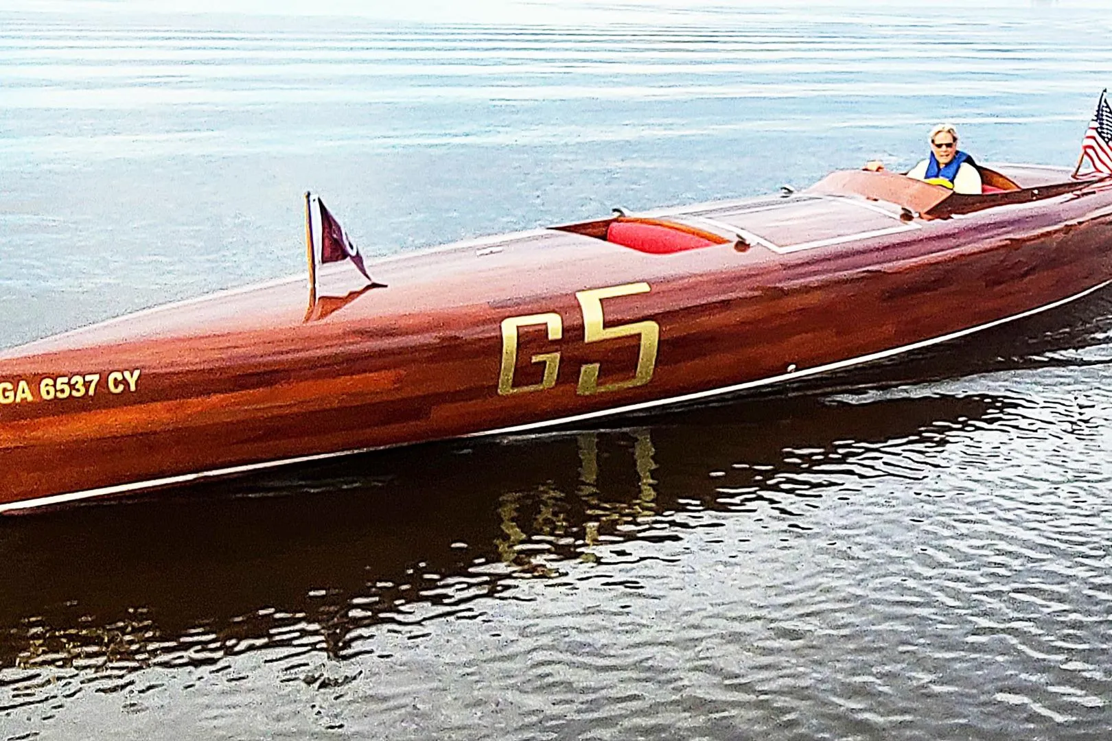 Custom 2024 Treworgy Replica of 30’ Baby Bootlegger boat on calm water.
