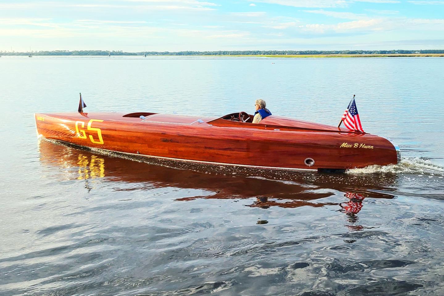 Custom 2024 Treworgy Replica of 30’ Baby Bootlegger on calm water, American flag displayed.