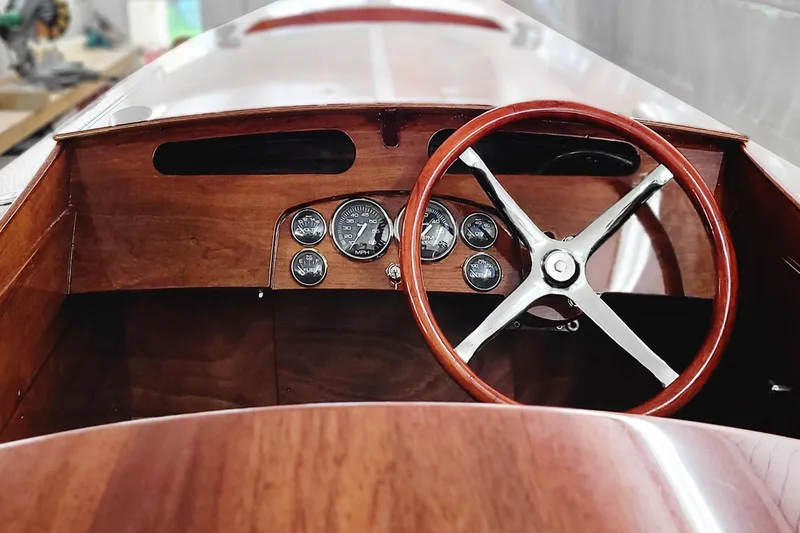  Yacht Photos Pics Interior of 2024 Treworgy Replica 30’ Baby Bootlegger with wooden dashboard and steering wheel.