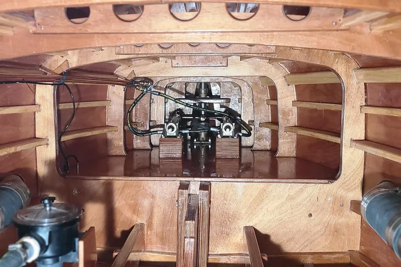  Yacht Photos Pics Interior view of 2024 Treworgy Replica 30’ Baby Bootlegger, showcasing wooden craftsmanship and engine components.