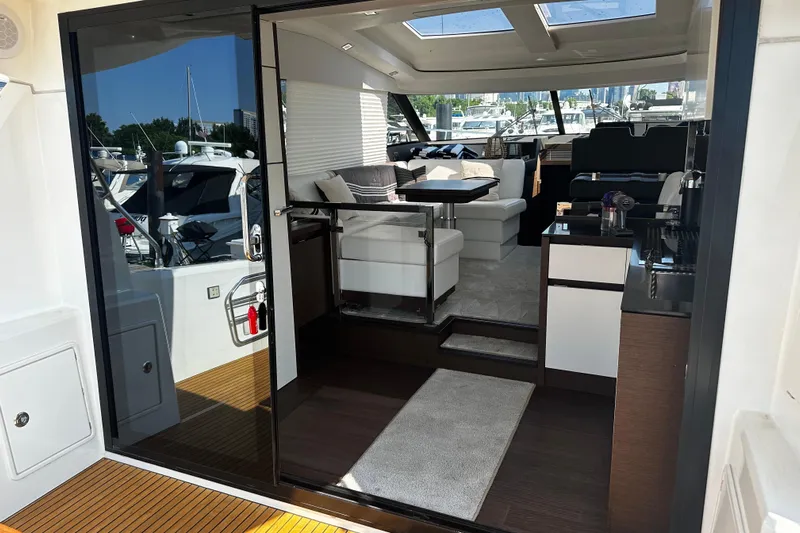 Seas The Day Yacht Photos Pics Luxurious interior of a 2018 Prestige 460 yacht with modern furnishings and sleek design.