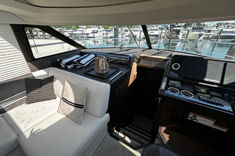Seas The Day Yacht Photos Pics Luxurious interior of 2018 Prestige 460 yacht with helm and seating area.