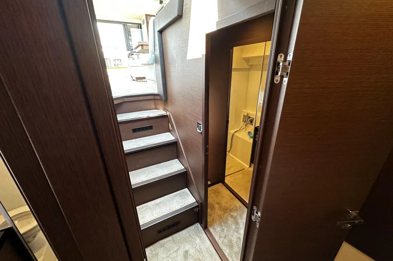 Seas The Day Yacht Photos Pics Interior of 2018 Prestige 460 yacht, featuring stairs and a doorway leading to a cabin.