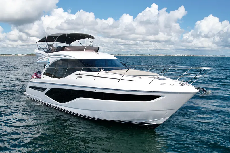  Yacht Photos Pics 2026 Princess F50 yacht cruising on open water under a partly cloudy sky.