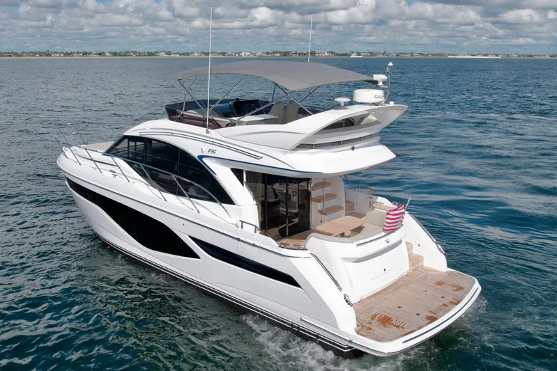  Yacht Photos Pics Luxurious 2026 Princess F50 yacht cruising on open water under a cloudy sky.