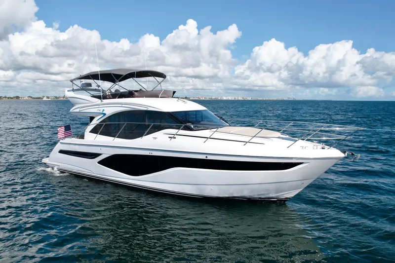  Yacht Photos Pics Luxury 2026 Princess F50 yacht cruising on open sea under blue sky.