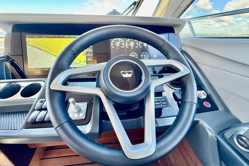  Yacht Photos Pics Steering wheel and dashboard of 2026 Princess F50 yacht, featuring modern navigation displays.