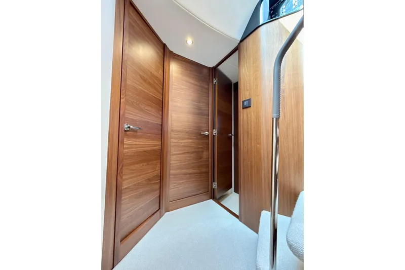  Yacht Photos Pics Interior hallway of 2026 Princess F50 yacht with wooden doors and modern design.