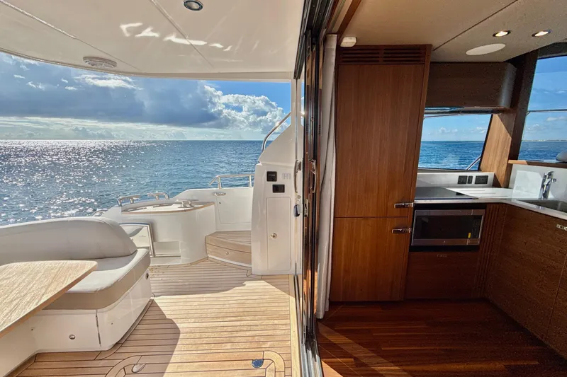  Yacht Photos Pics Luxurious 2026 Princess F50 yacht interior with ocean view, featuring elegant wood finishes.