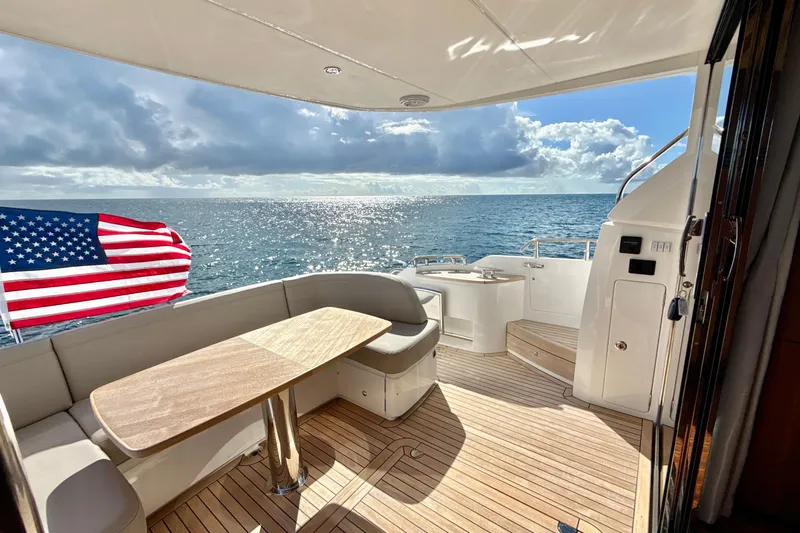  Yacht Photos Pics Luxurious 2026 Princess F50 yacht deck with ocean view and American flag.