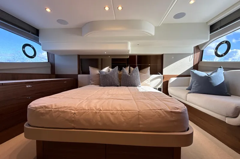  Yacht Photos Pics Luxurious bedroom interior of 2026 Princess F50 yacht with elegant bedding and seating.